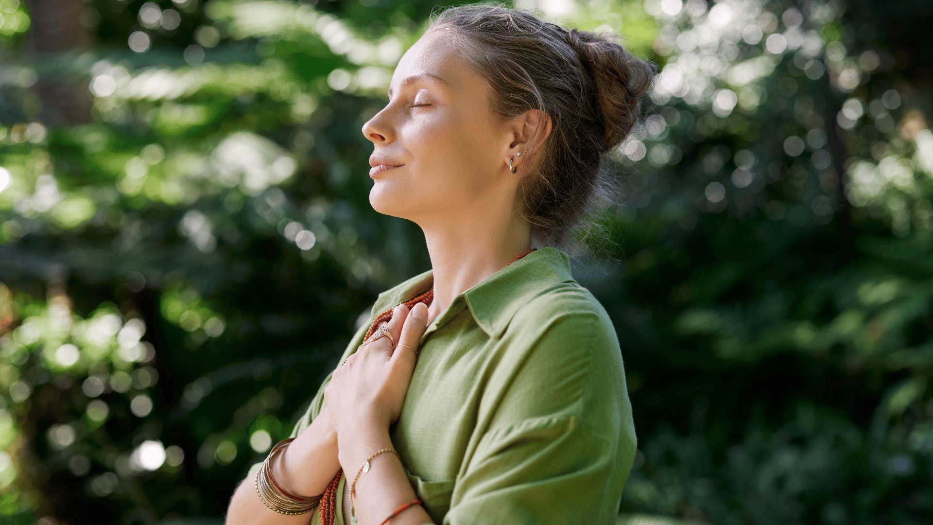 woman meditating outside to emotionally ground herself