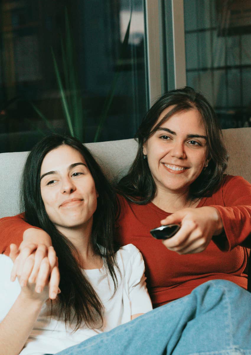 woman watching tv together on a couch