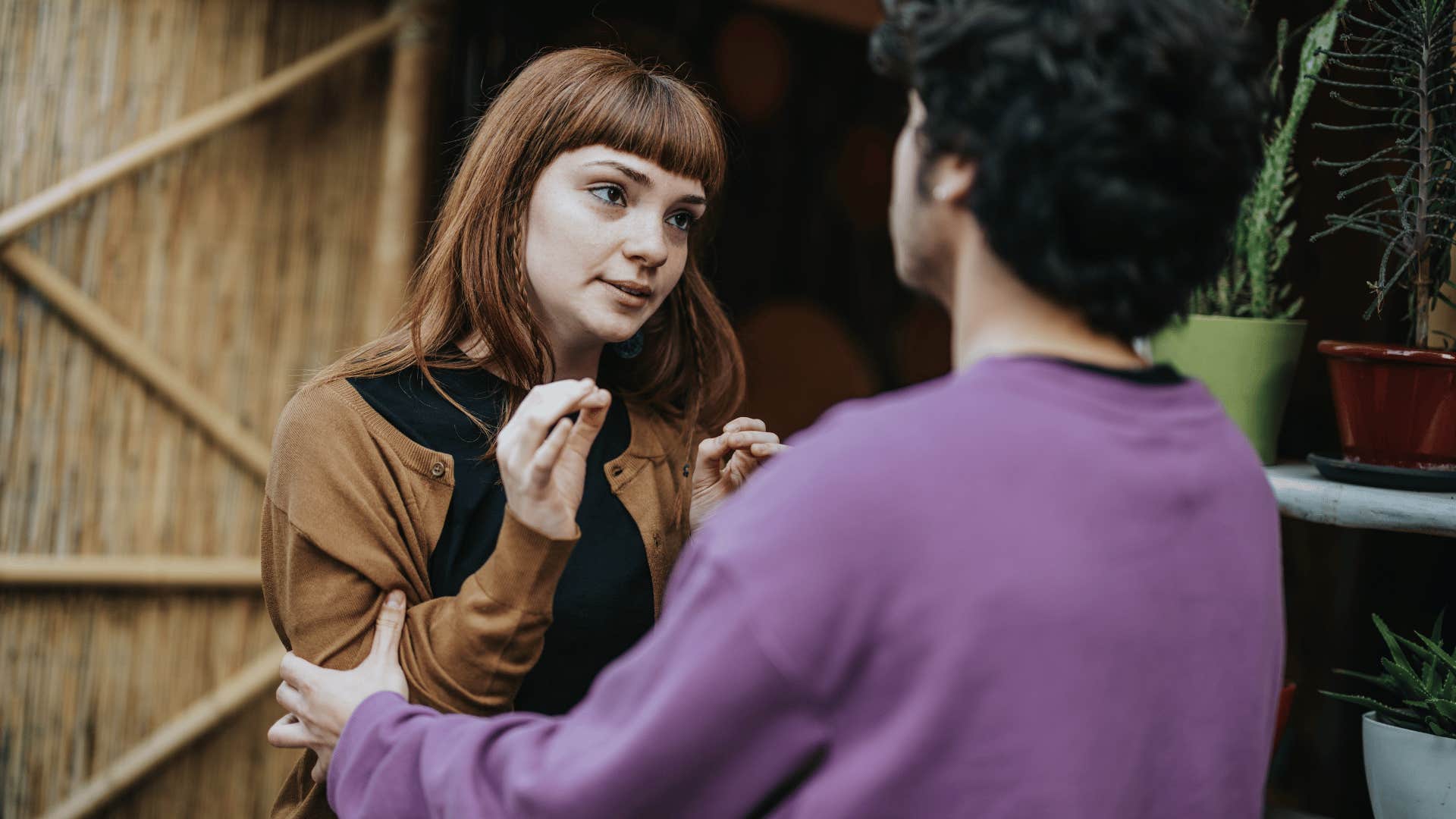 annoyed woman telling man i need one second