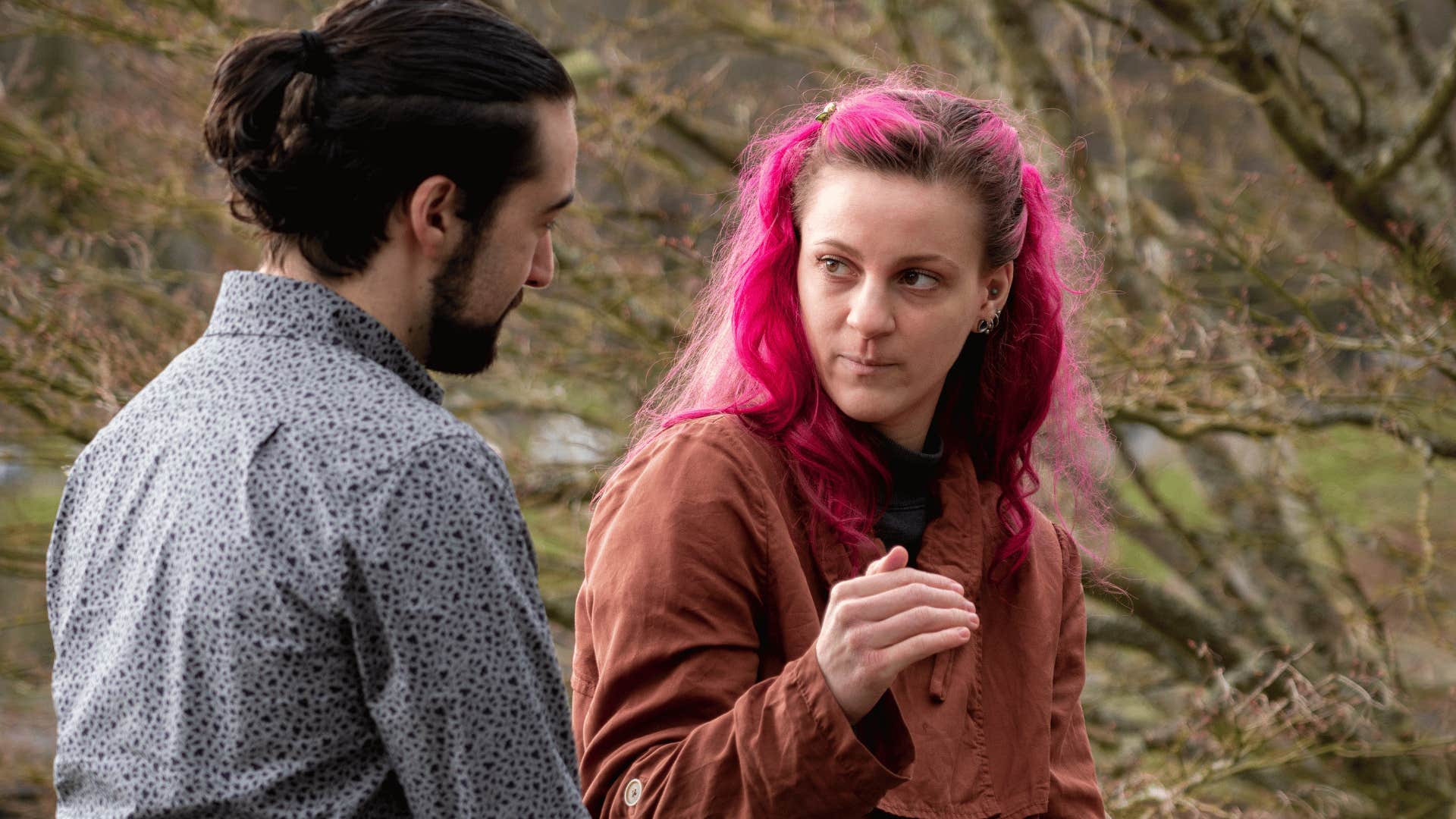 assertive woman telling man she's not looking for advice in tense exchange