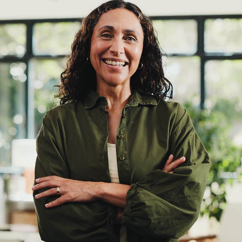 confident woman who learned to believe in herself smiling at work