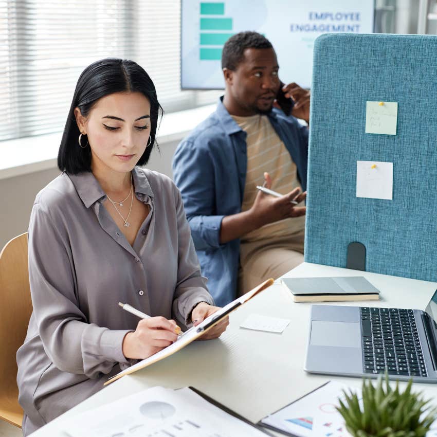 woman working in a cubicle prefers the privacy to open office plan