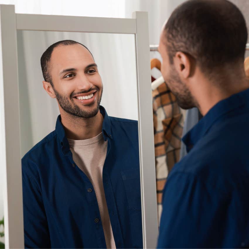 vain fake man looking in mirror to check his appearance
