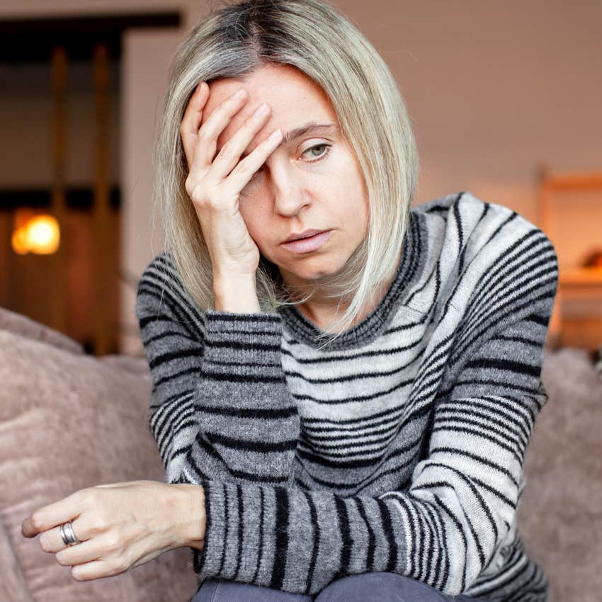 woman feeling miserable at home thinking about failure