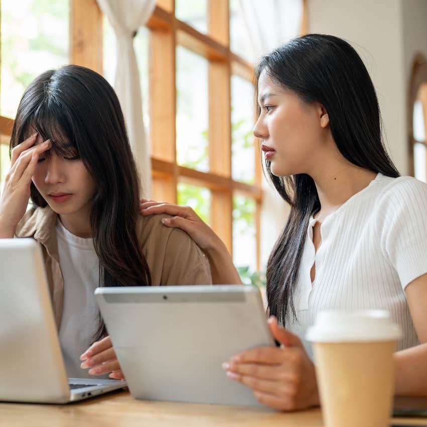 miserable woman sitting next to friend and thinking about other people