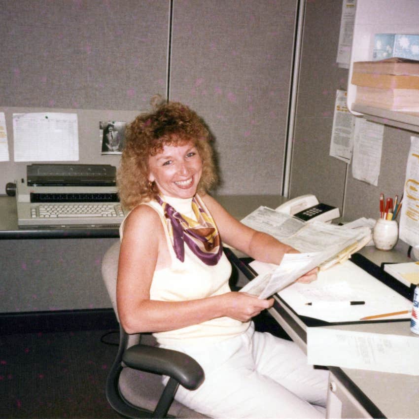 Woman working in an '80s office before computers and cell phones