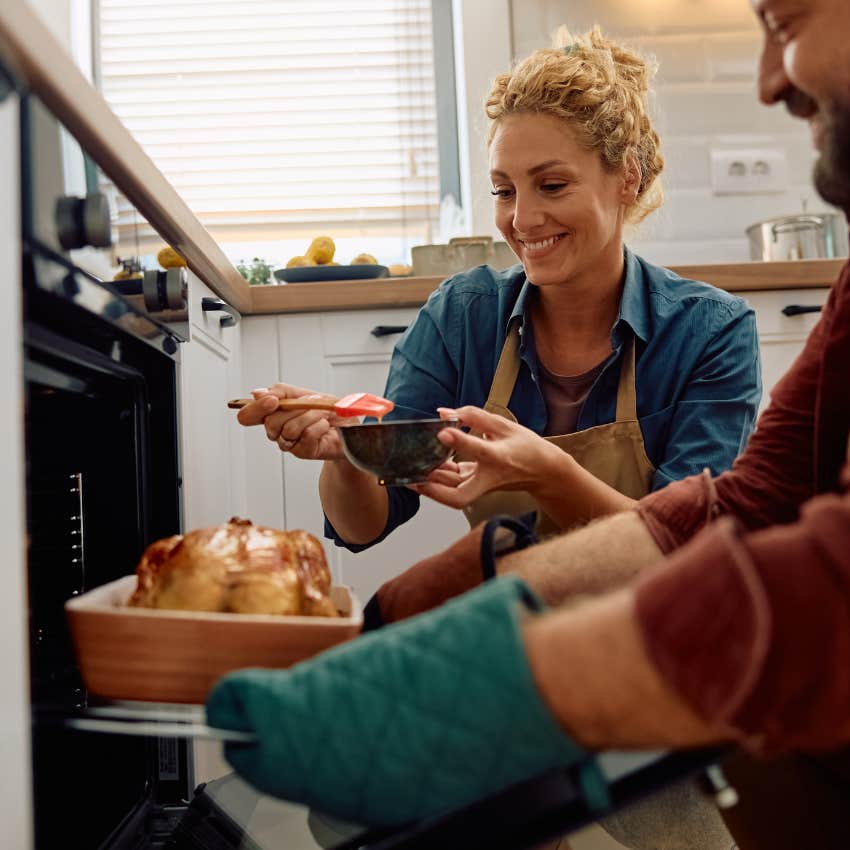 Couple cooking chicken at home