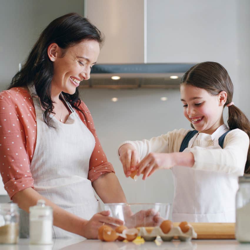 Woman making an omelette with her daughter