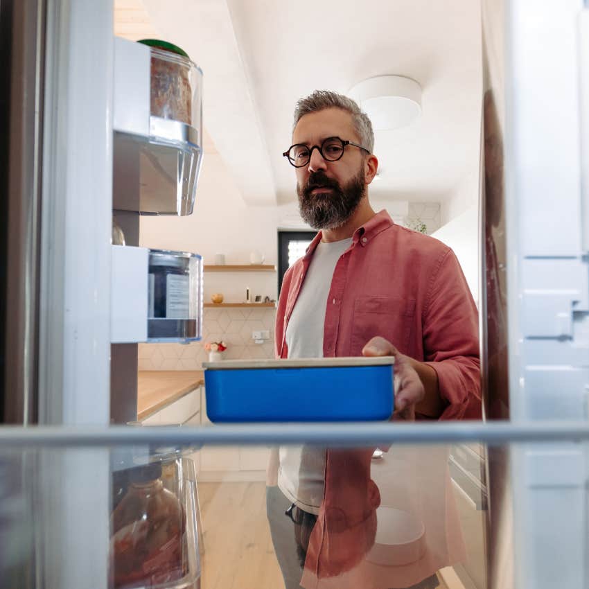 Man storing leftovers at home