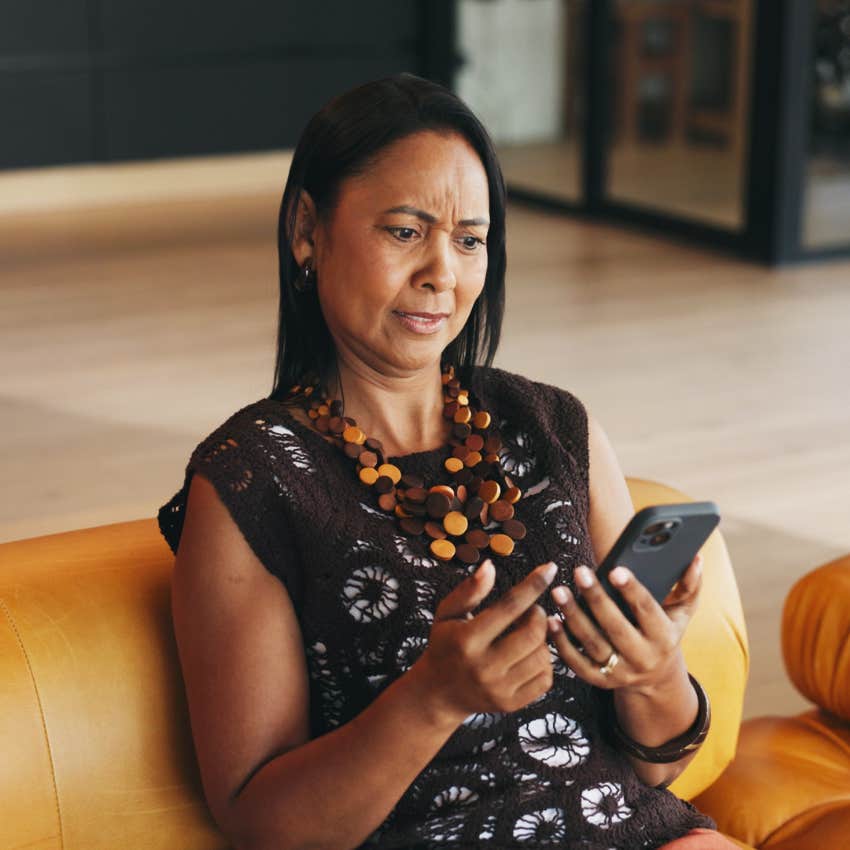 intelligent woman annoyed looking at internet arguments on her phone