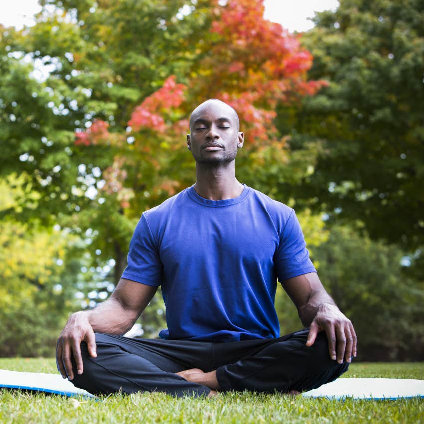 Man who works a physically taxing job meditates to relax
