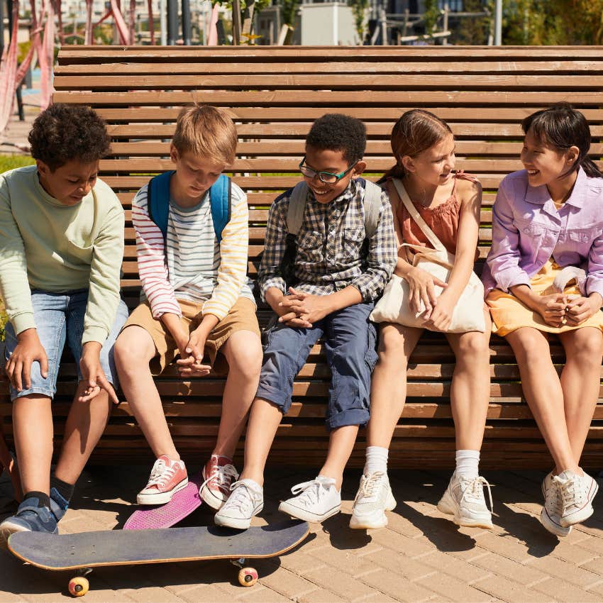 Kids hanging out together on a neighborhood bench instead of communicating through screens