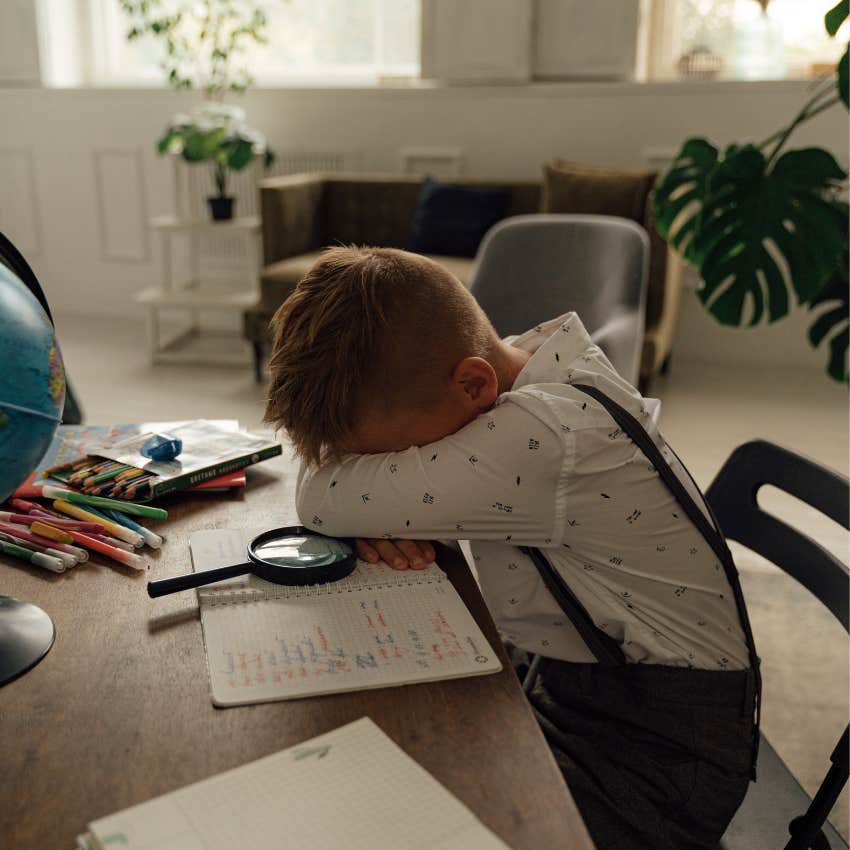 Young child laying his head on the table while upset learning to tolerate boredom and disappointment