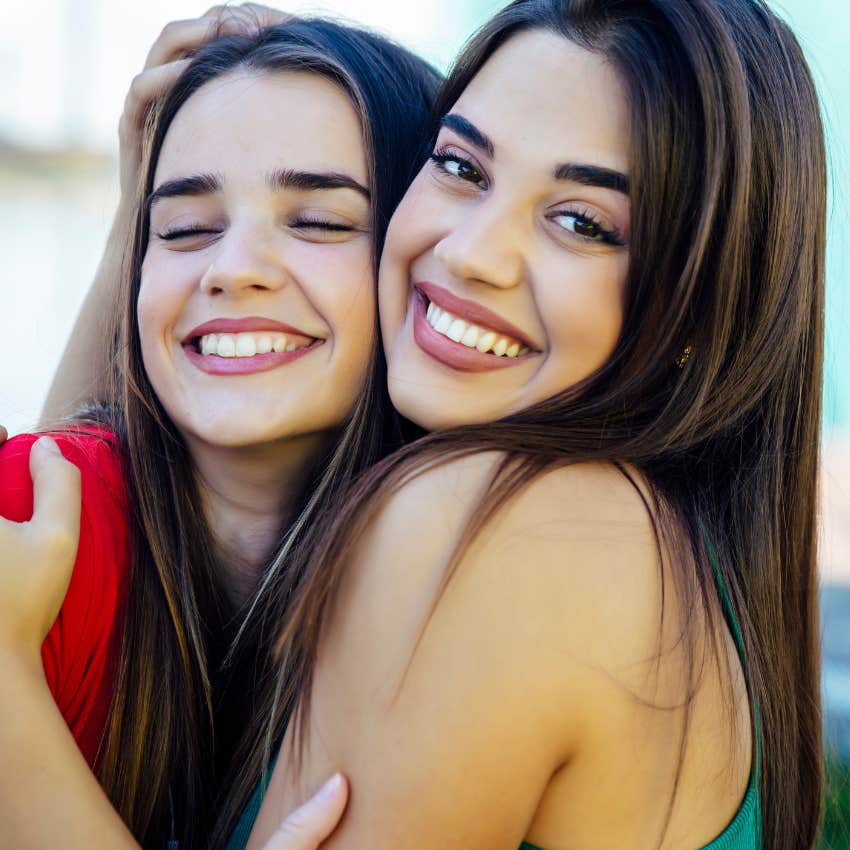 Girl still hugging her friend even though she thinks she's annoying