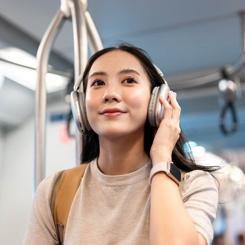 woman wearing headphones on public transport