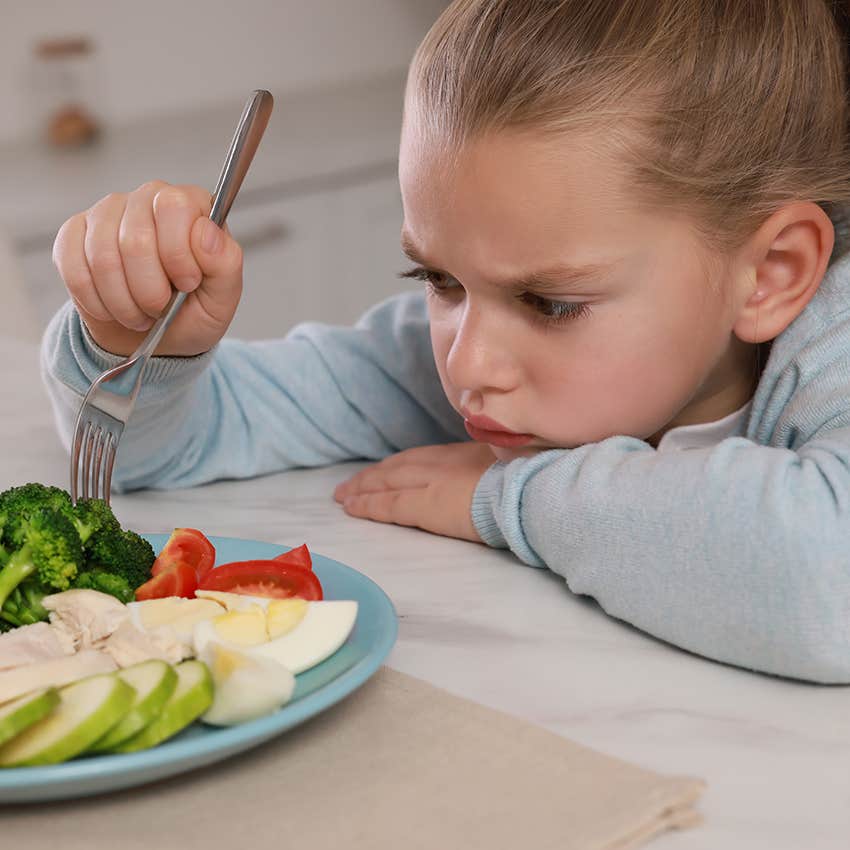 little girl eating a home cooked meal but being picky about it