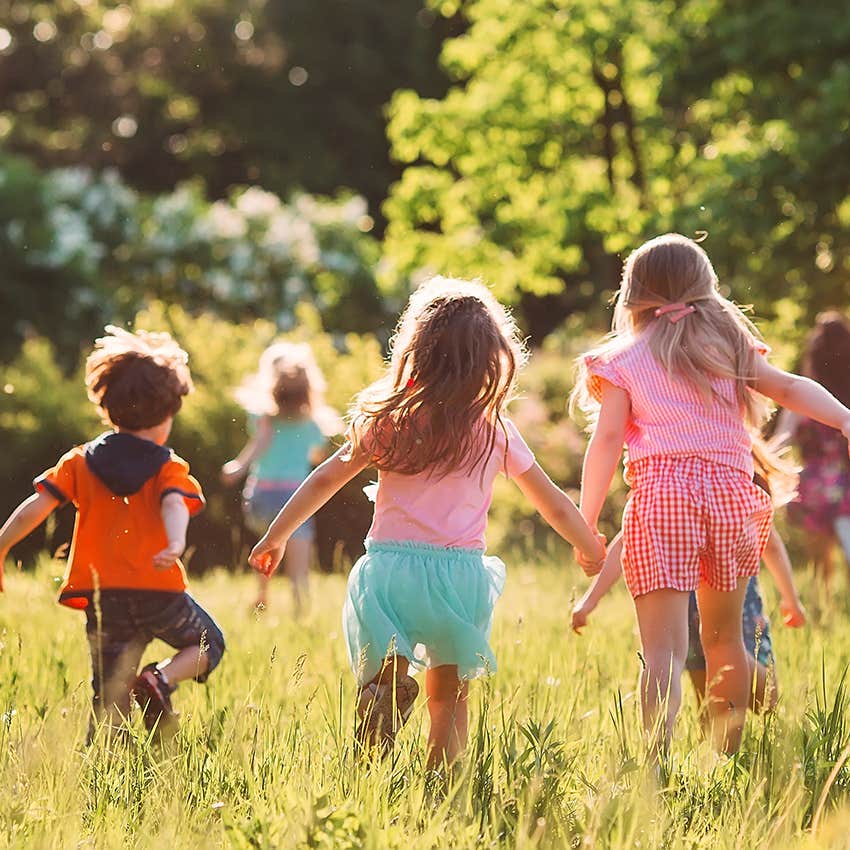 group of kids playing outside in field running