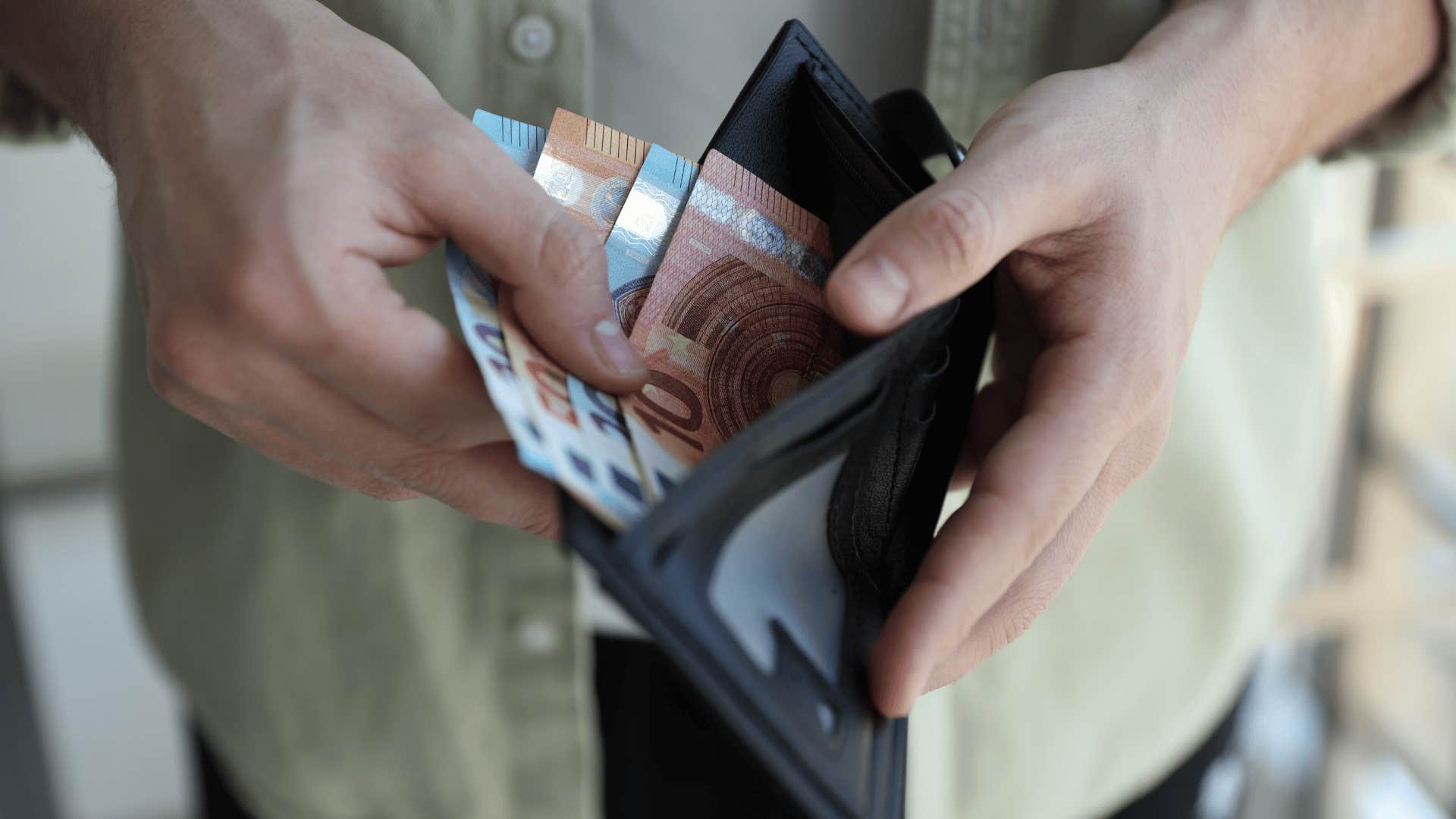 man opening wallet managing money for retirement