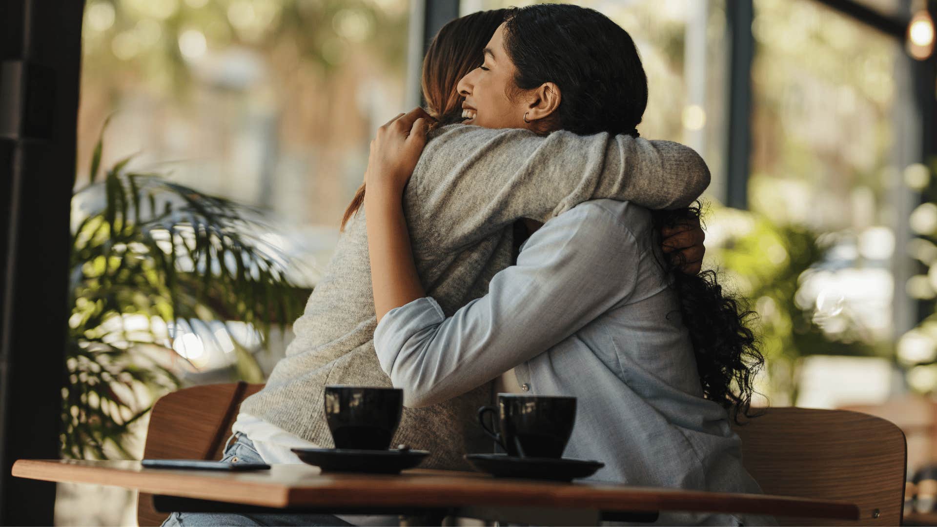 two millennial friends hugging creating a community