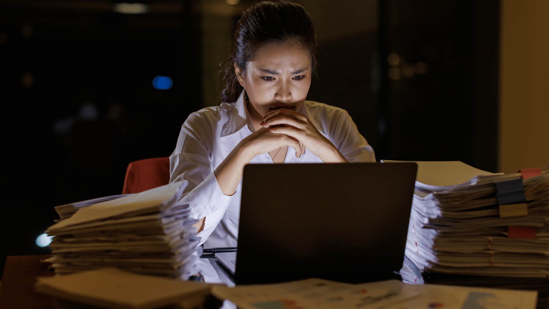 gen z woman looking worried staring at laptop