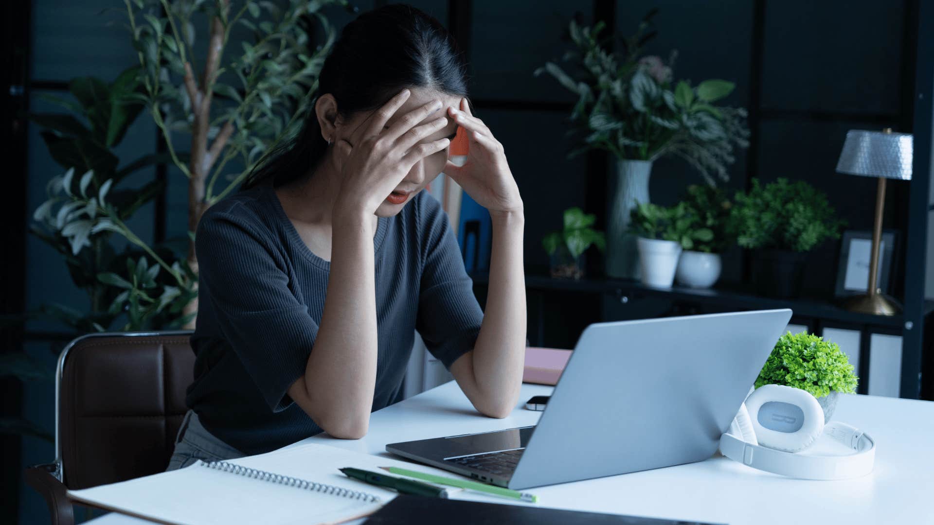 young woman staring at laptop stressed about buying a home