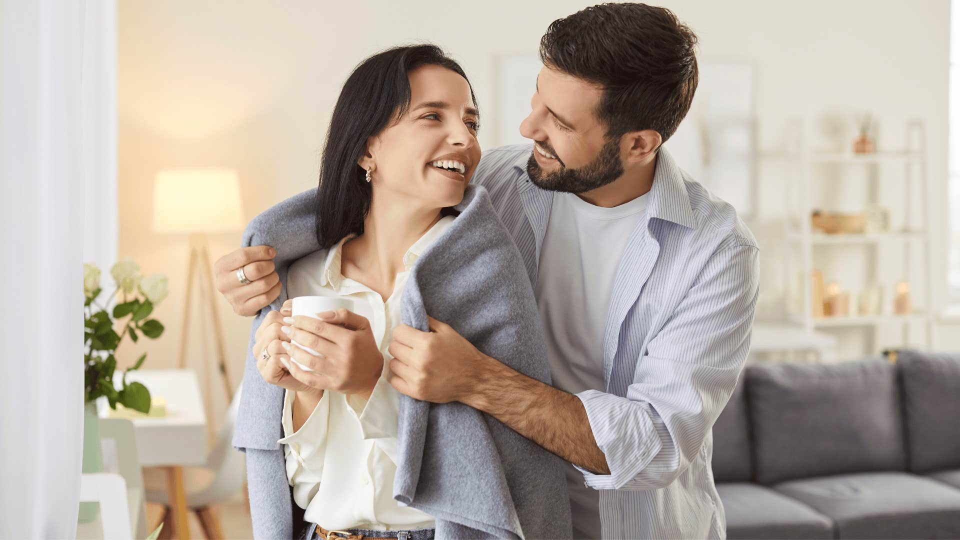 millennial couple hugging thinking about starting a family