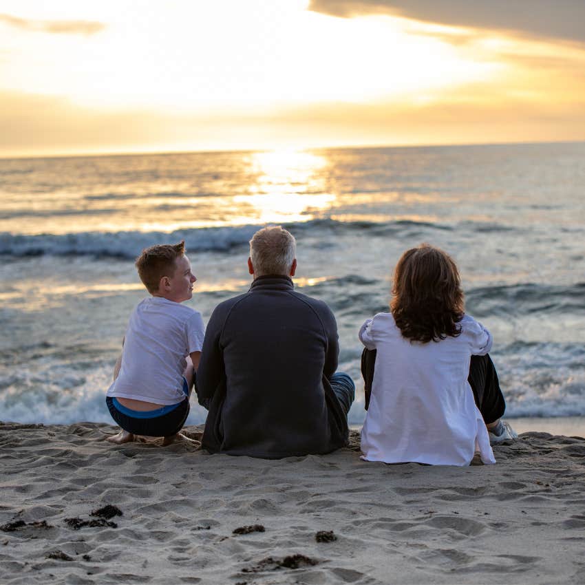 Family watching a beautiful sunset together without anyone looking at a phone or taking photos