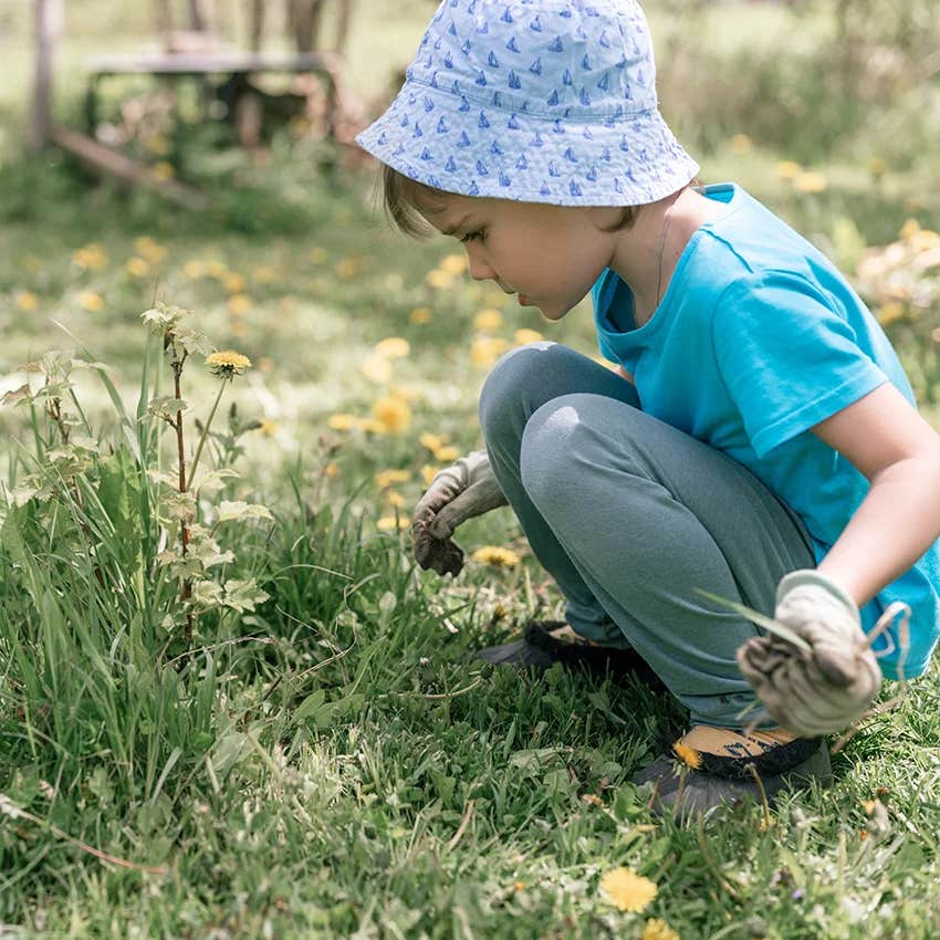little kid doing the boring weekend chore of weeding that will prep them for real life
