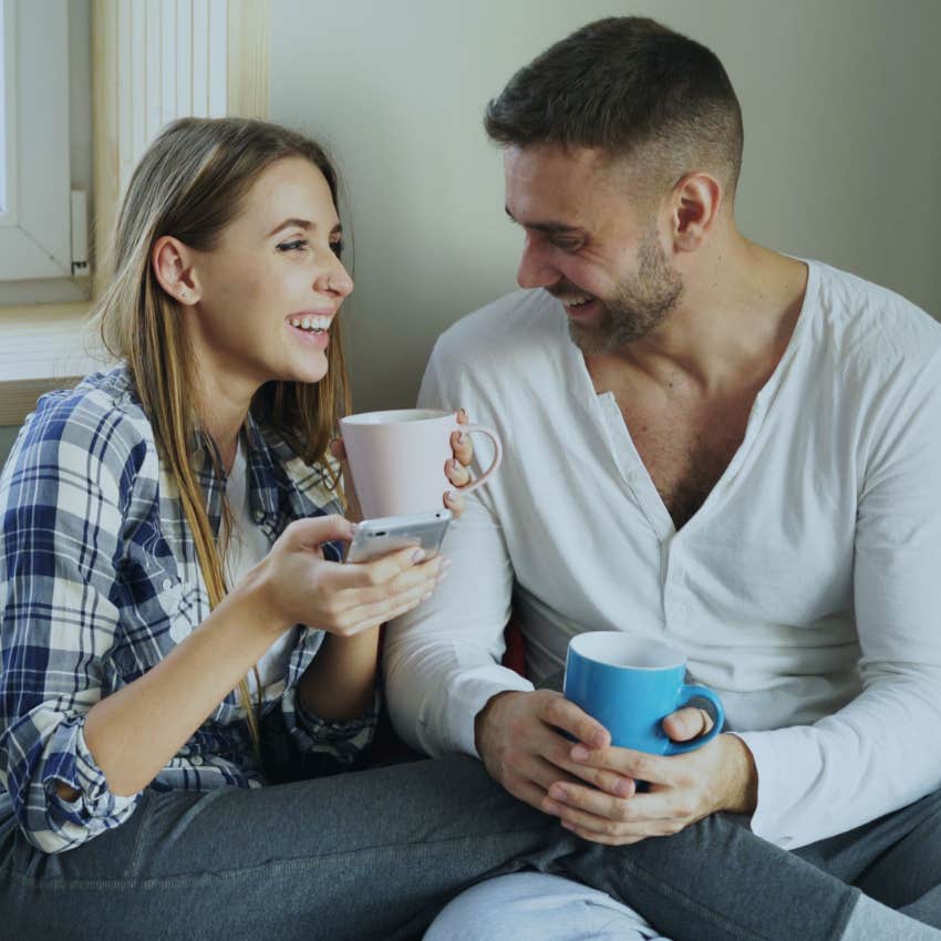 Happy couple laughing together while enjoying a simple everyday moment at home