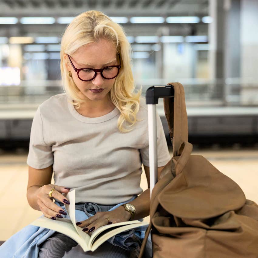 intelligent antisocial woman saying I'm happy with my book at the airport
