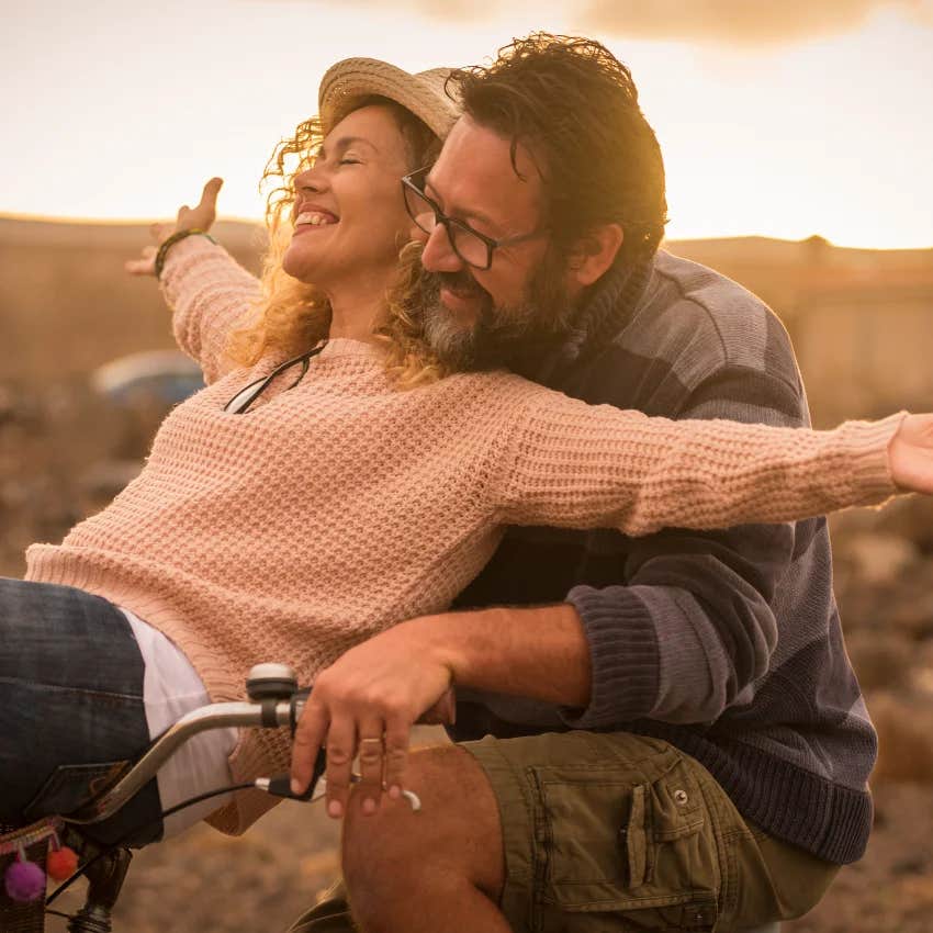 couple who loves summer basking in the nostalgia of an old fashioned bike ride