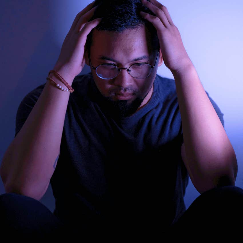 emotionally distraught man sitting on the floor