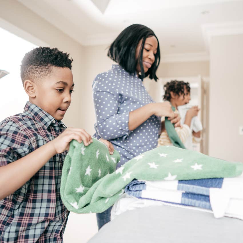 kid doing their chores folding laundry with their mom