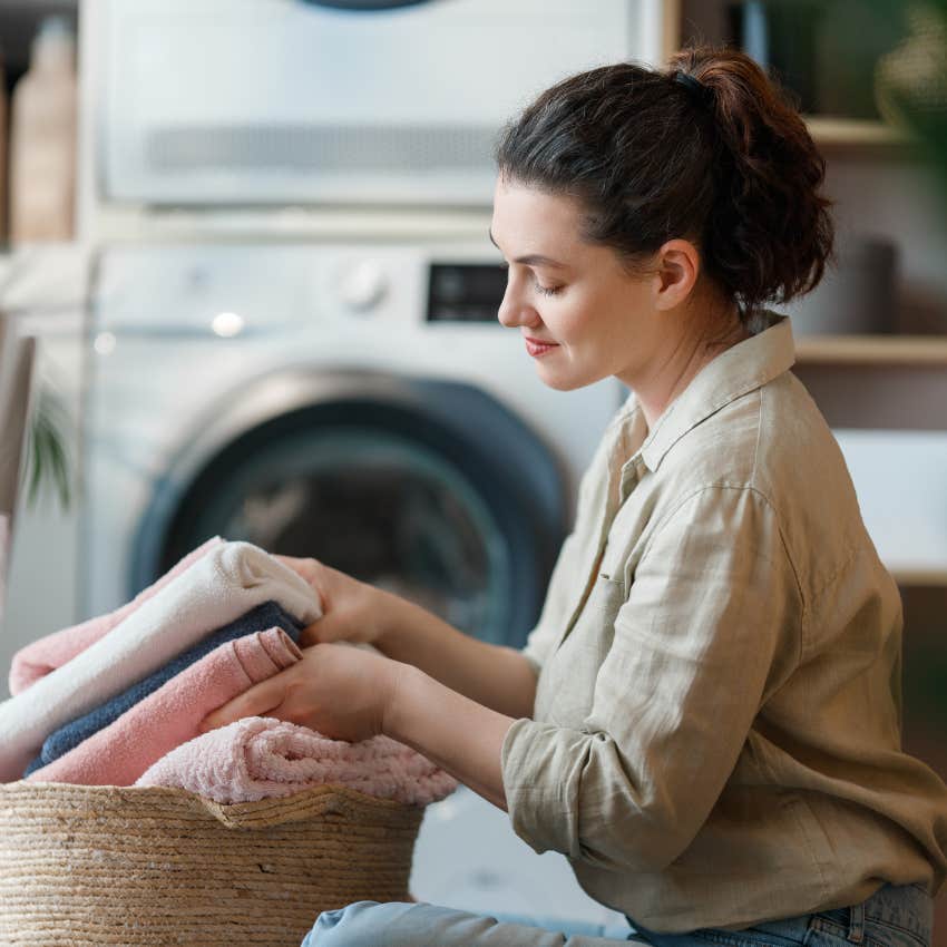 woman doing laundry like it's meditation
