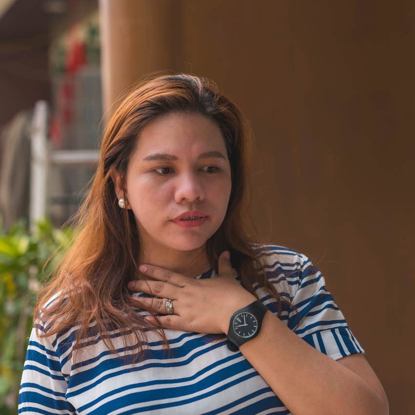 woman feeling physical discomfort recognizing it as a sign from her intuition