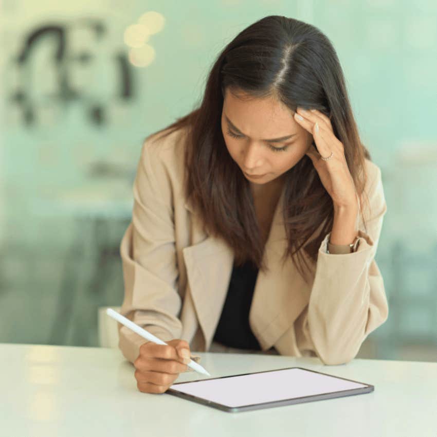focused woman using tablet preparing failure