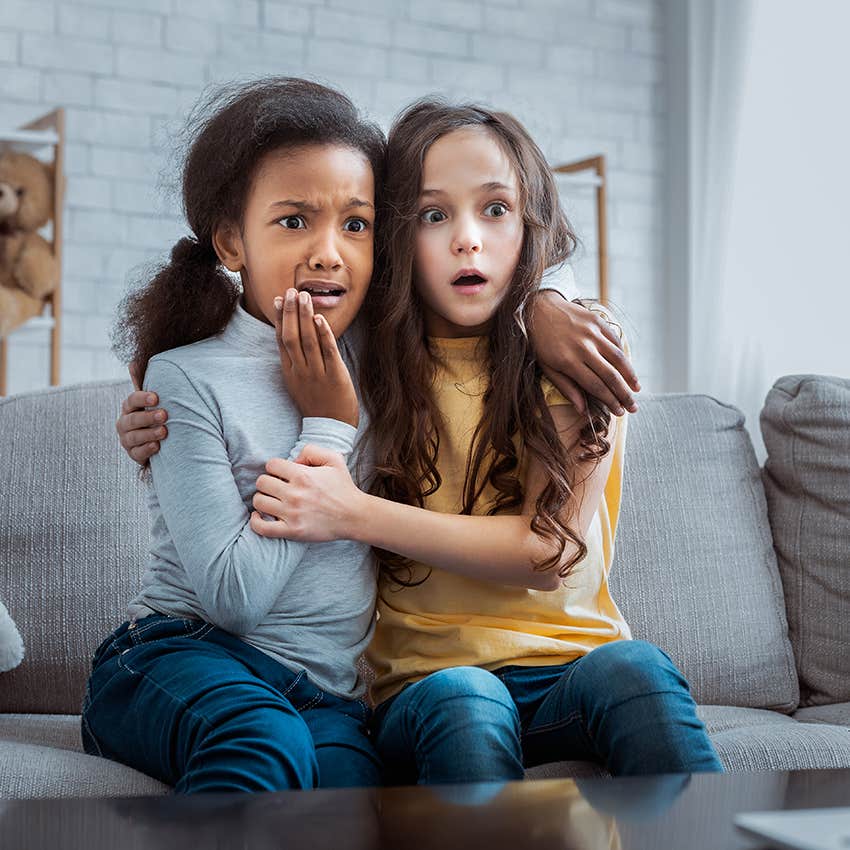 two girls shocked while watching scary movie together
