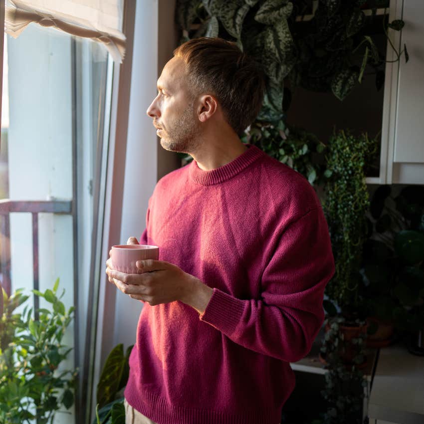 gen x man looking out the window deep in thought