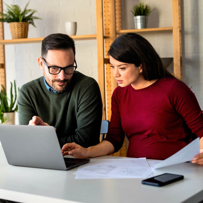 Gen X couple balancing their bank account on computer