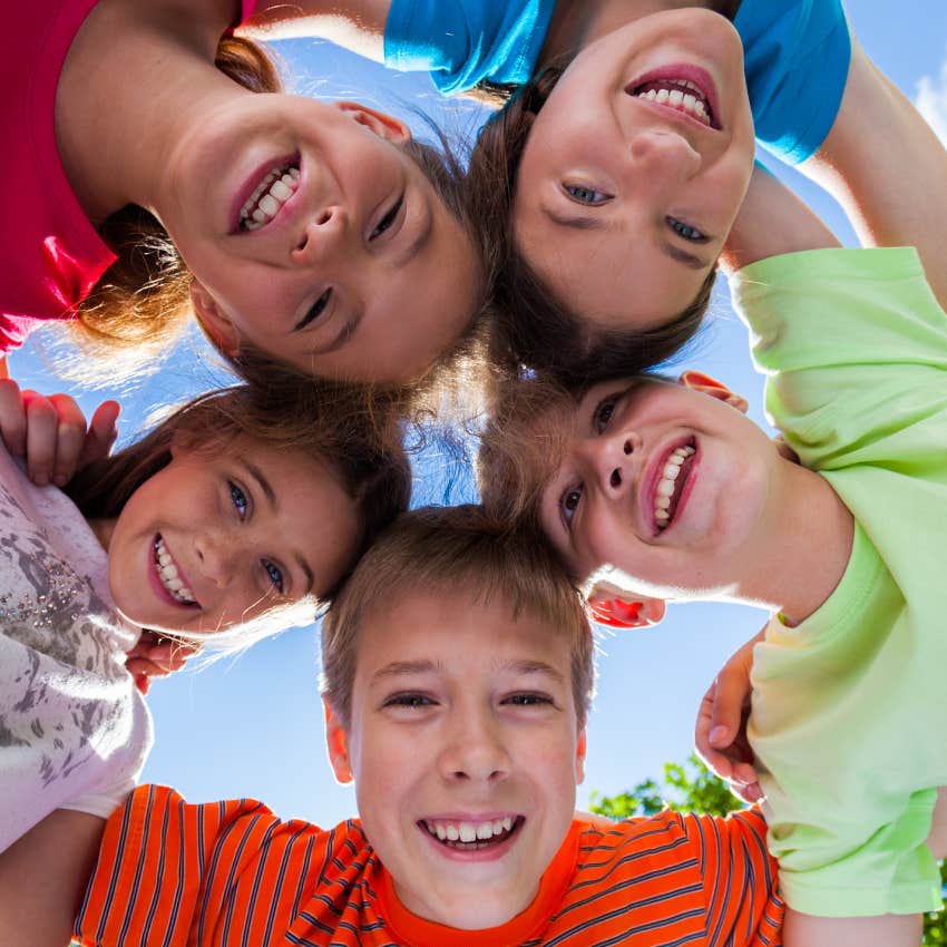 kids in the same community hugging and smiling