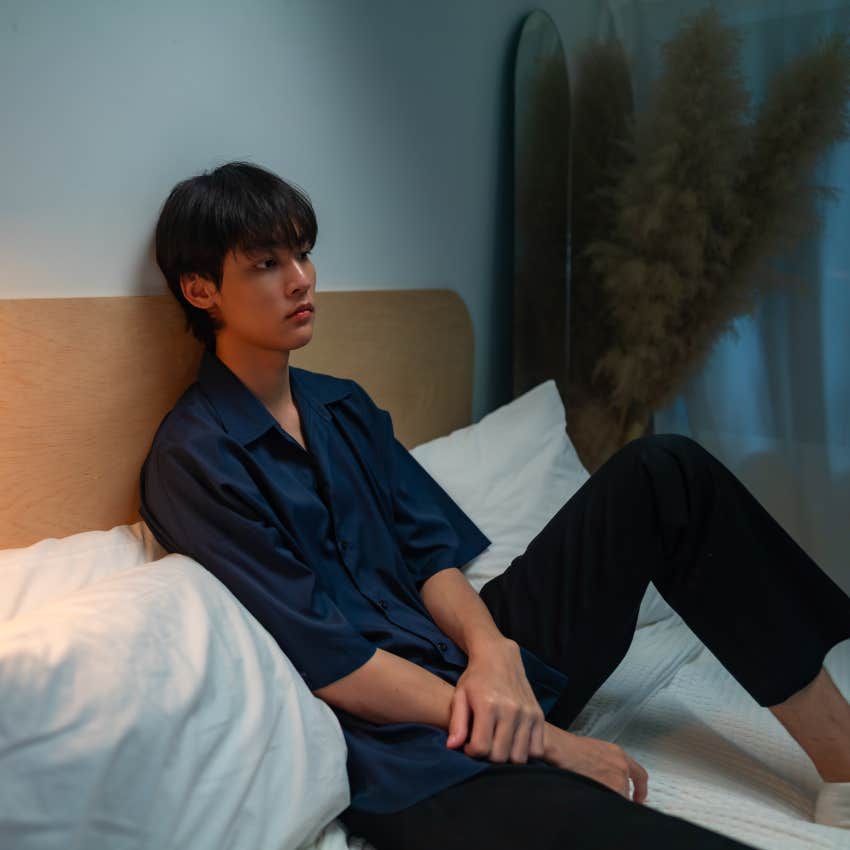 gen z man pondering what it means to be lonely alone at home