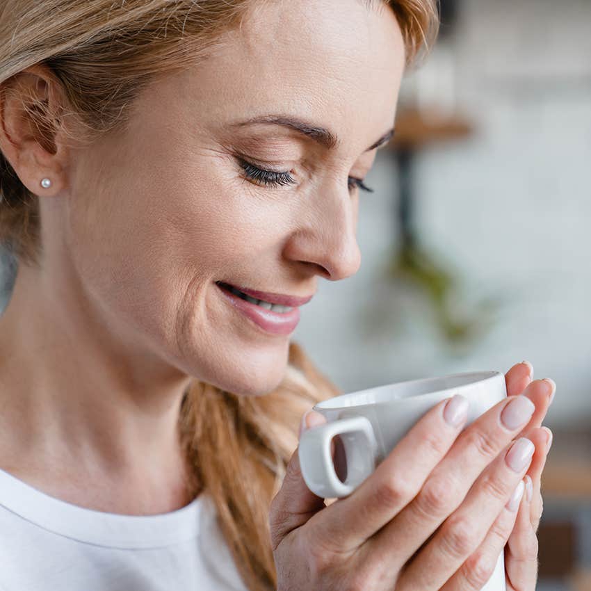 middle aged woman drinking coffee in morning