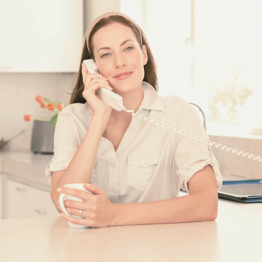 woman getting busy signal on landline phone