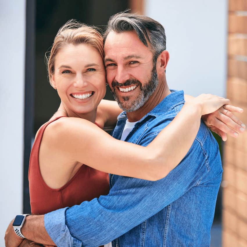 happy couple hugging each other close 