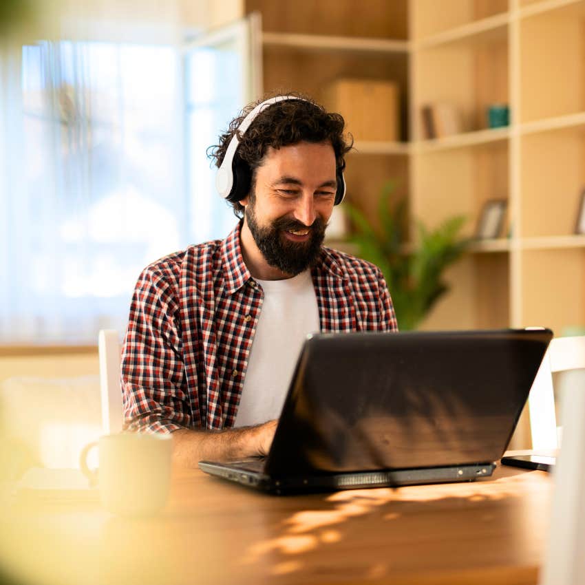 creative man on the computer sitting in messy home