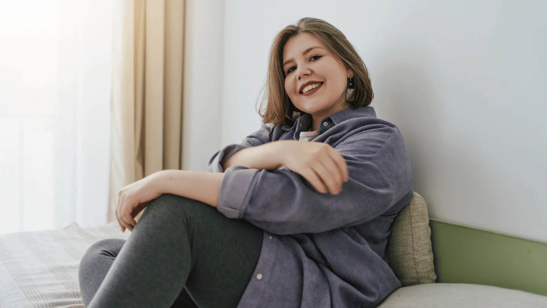 intuitive woman smiling at home trusting herself