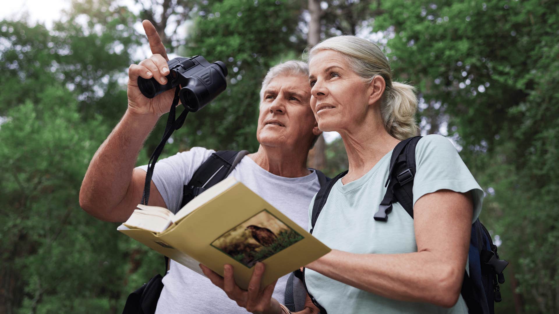 happy couple with deep personalities birdwatching outside