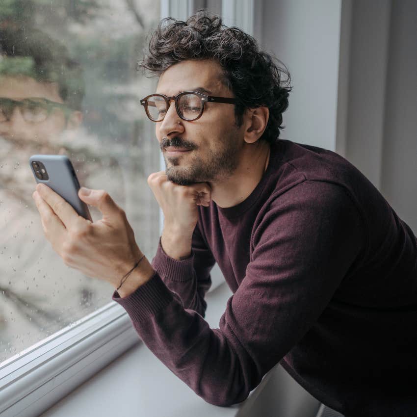 man on his phone feeling powerful from people gossiping about him