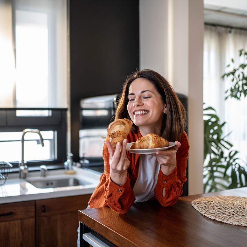 middle class woman eating breakfast before work