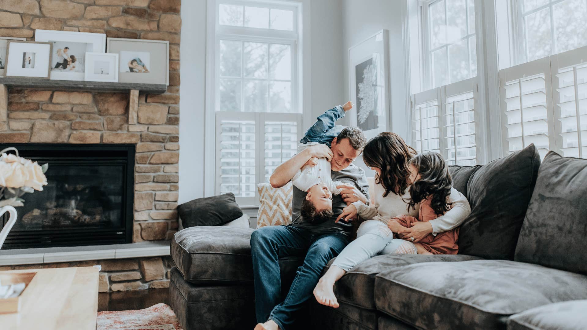 happy couple with family photos in their living room